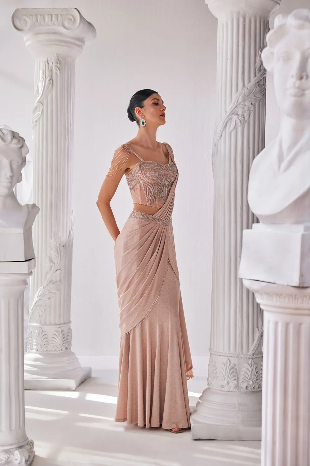 Peach Draped Saree In Luxurious Shimmer Lyrcra. It Is Paired With Anembroidered Corset Blouse And Highlighted With A Statement Belt.