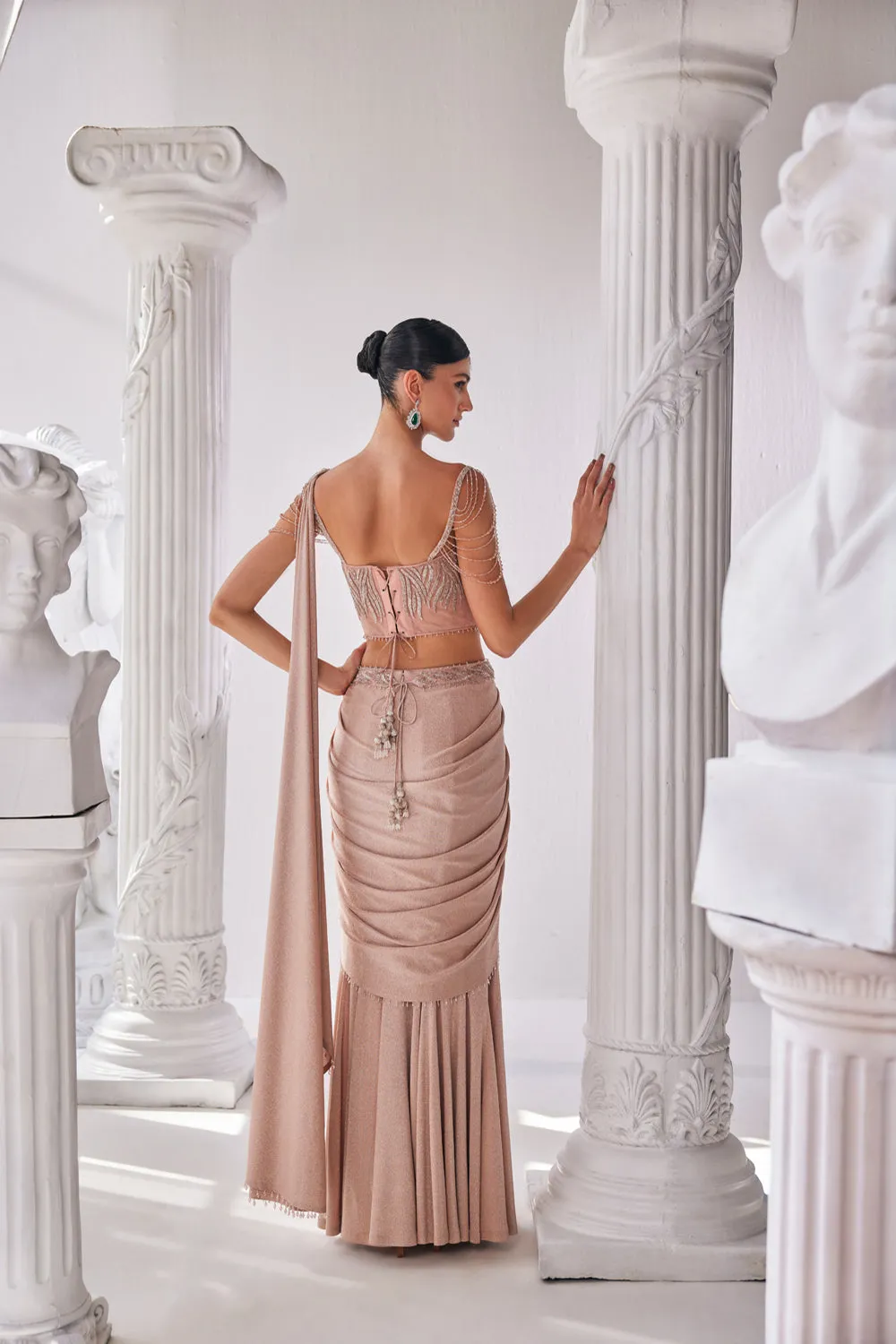 Peach Draped Saree In Luxurious Shimmer Lyrcra. It Is Paired With Anembroidered Corset Blouse And Highlighted With A Statement Belt.